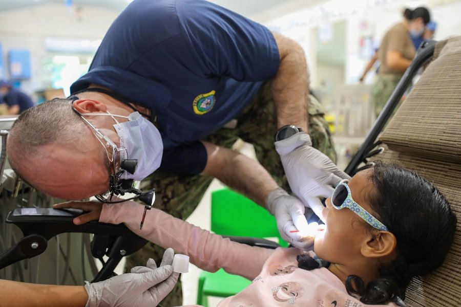 Pediatric dentist examining a young girl's teeth